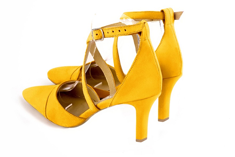 Yellow women's open side shoes, with crossed straps. Tapered toe. High slim heel. Rear view - Florence KOOIJMAN